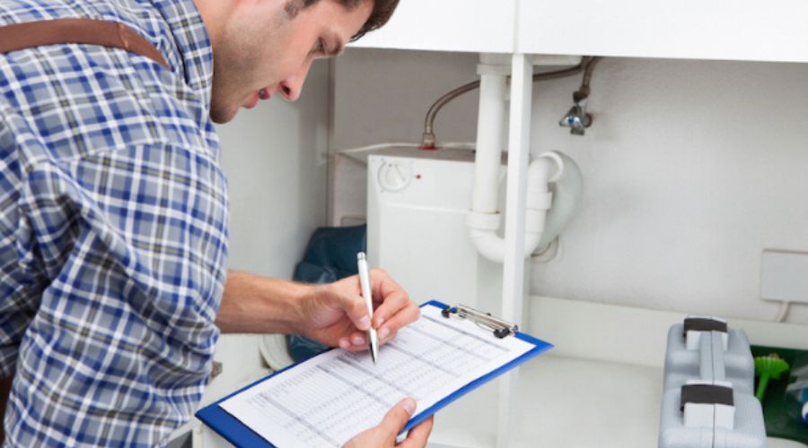 plumber inspecting sink drains